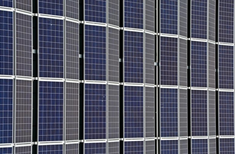 Close-up of multiple solar panels representing renewable energy and sustainability.