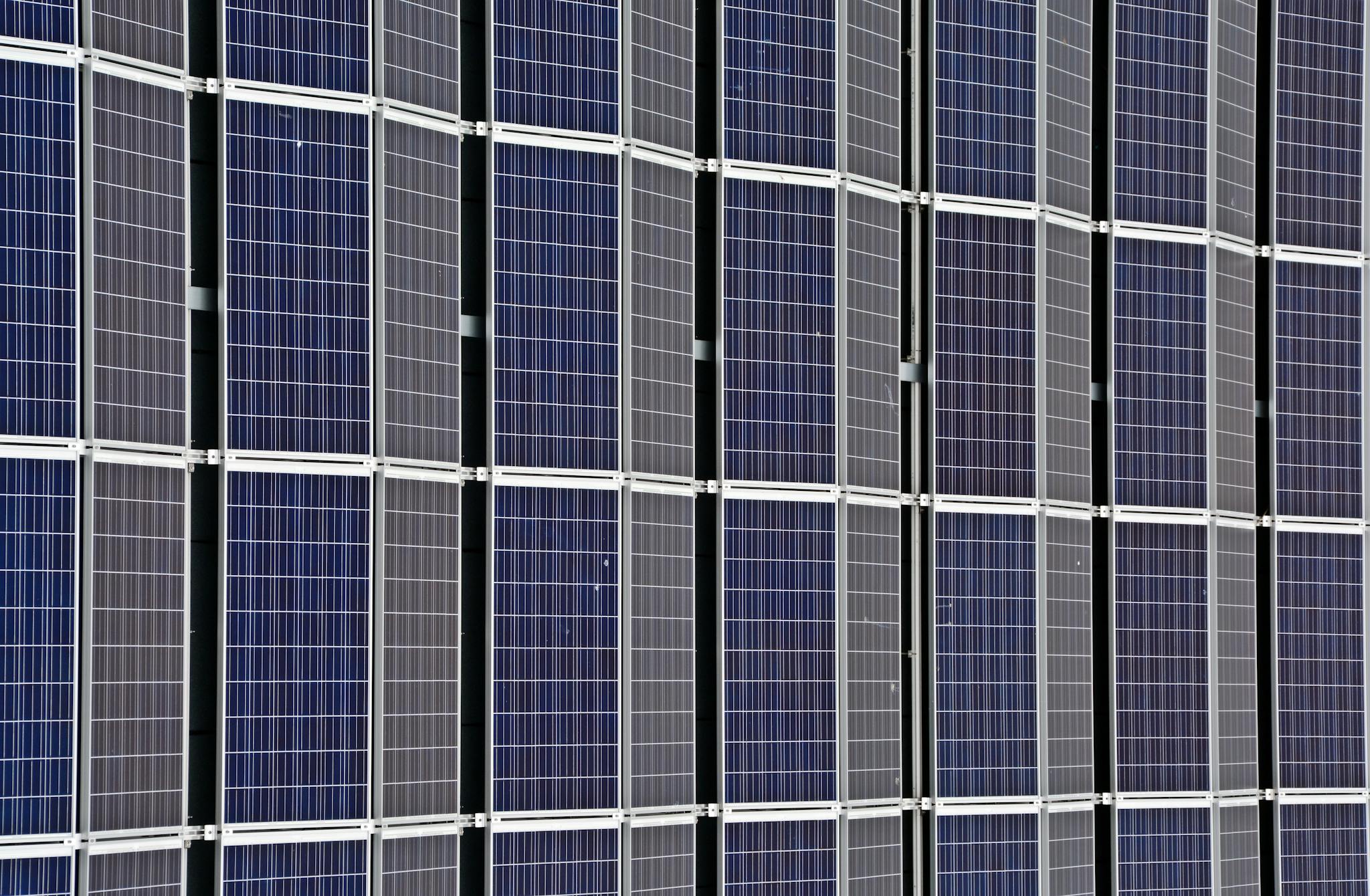 Close-up of multiple solar panels representing renewable energy and sustainability.